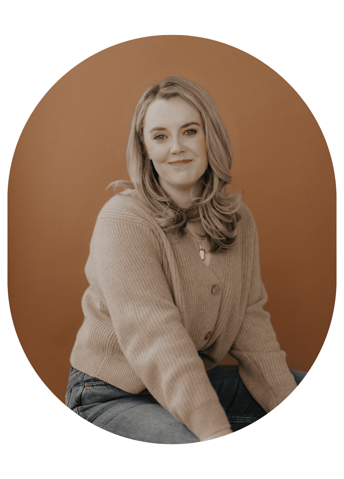 Alex Alexander seated in tan sweater, neutral background — promoting her message about community and connection.